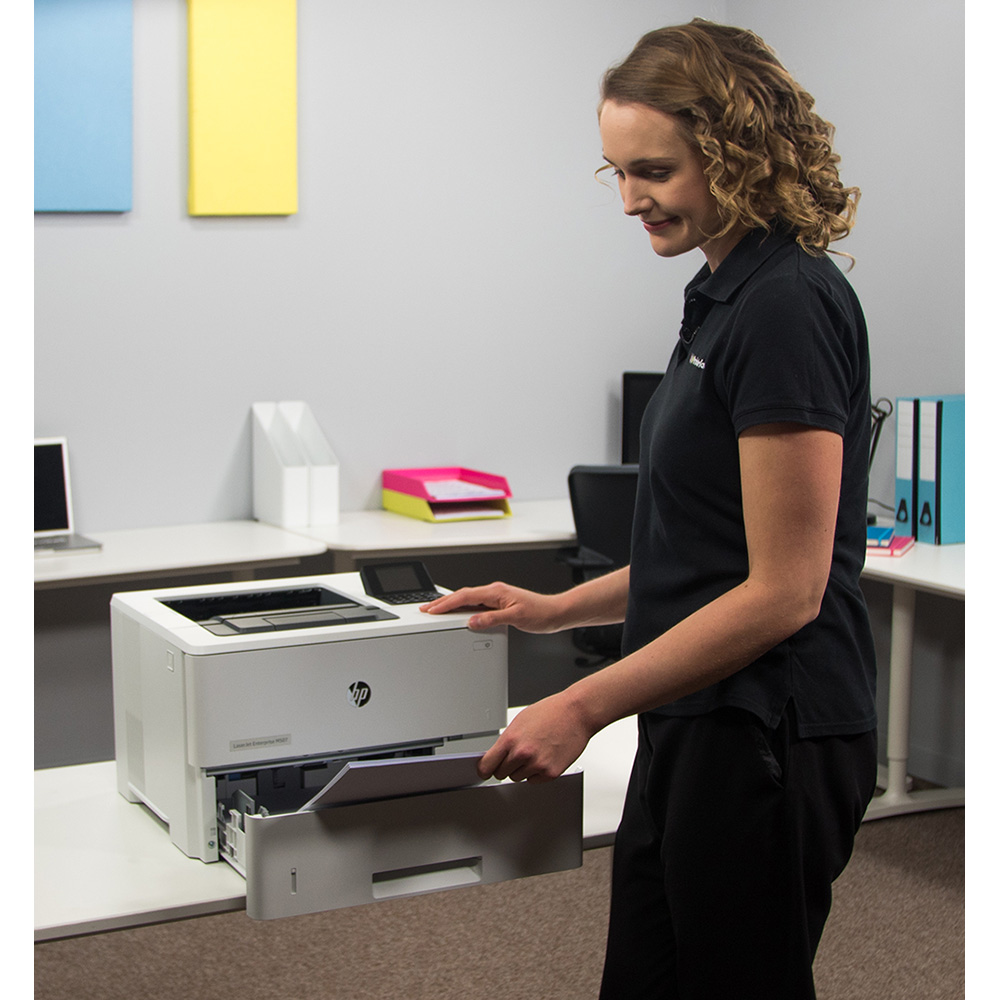 Woman adding paper to printer