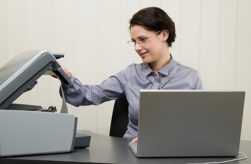 Woman working with the printer, smiling