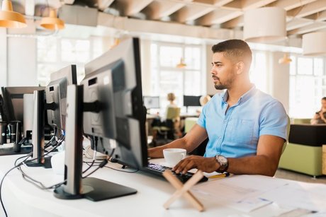 Guy using computer at desk