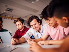 Man teaching 4 children