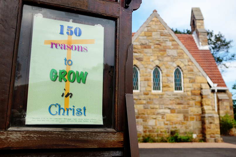 Inspirational Christian message outside suburban church